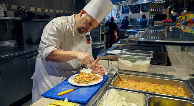 Chef Ian Camilleri prepares pancakes made with coconut milk topped with fruit and whipped cream. (Photograph by Christie Vuong)